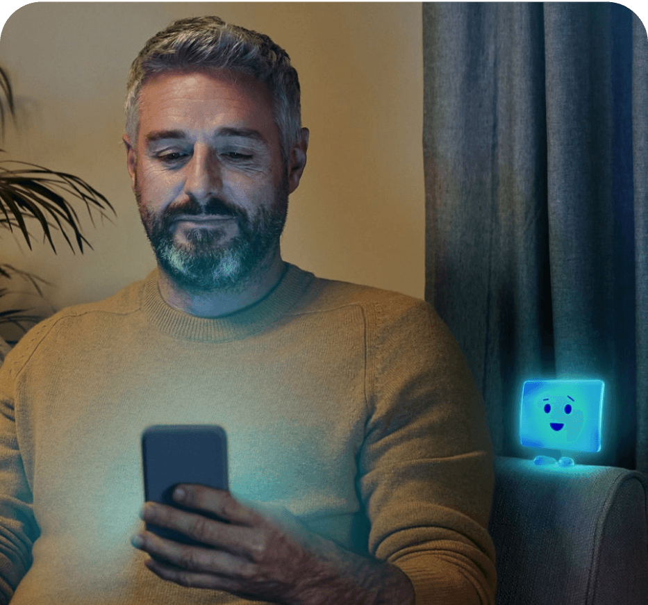 A man smiling at his phone