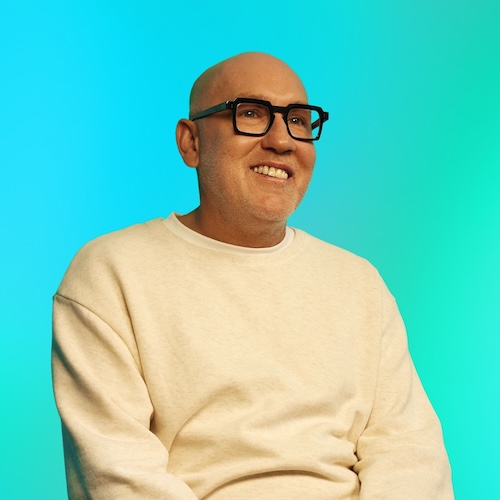 James, a man with glasses smiling